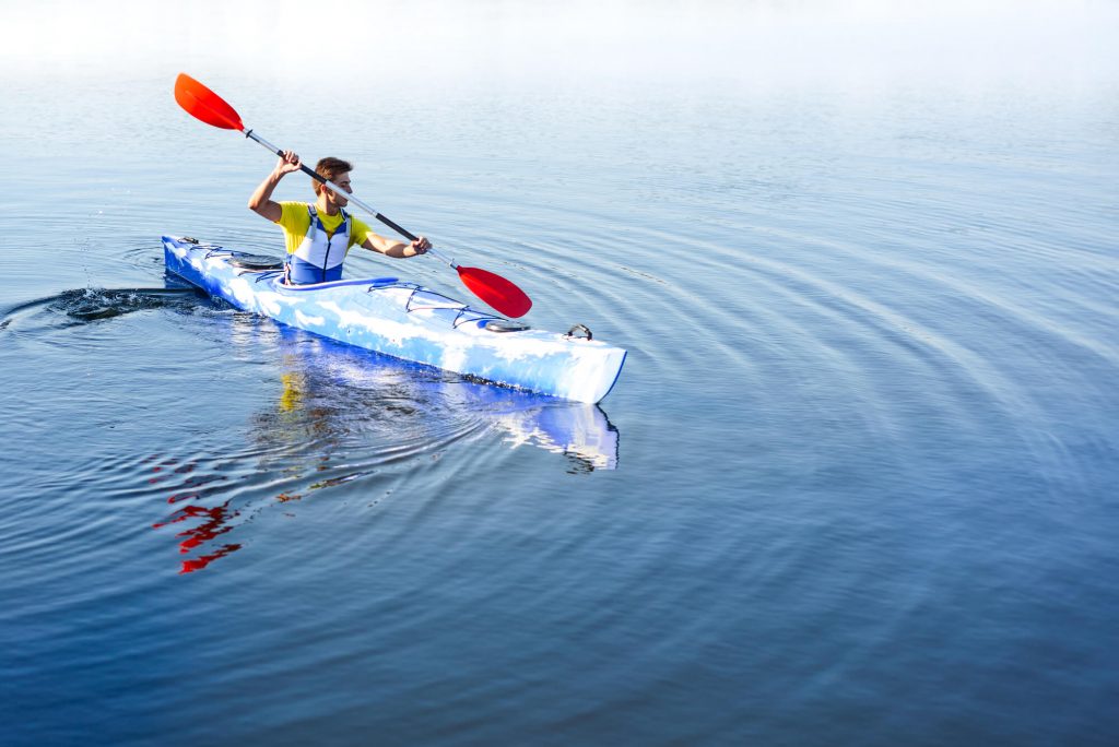 young man in blue kayak